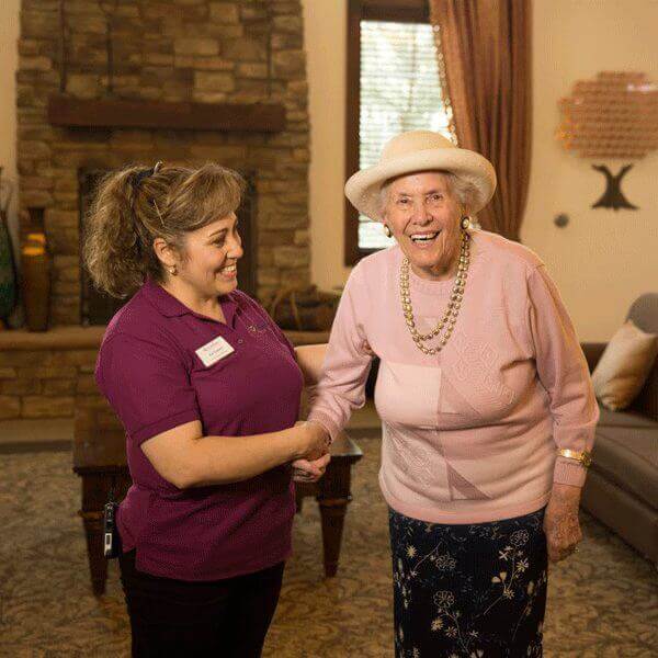 Happy resident and staff at Elk Grove Community